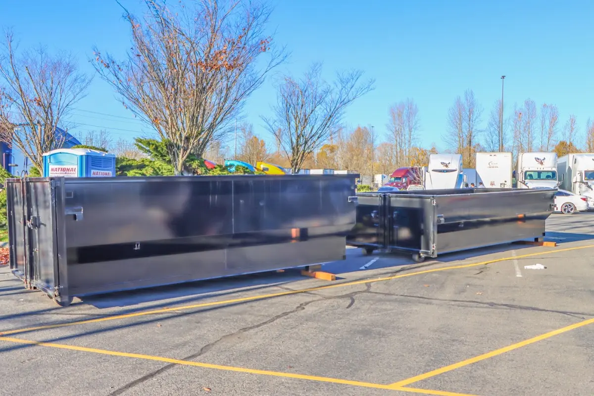 Professional dumpster rental service with roll-off container on residential driveway in River Forest